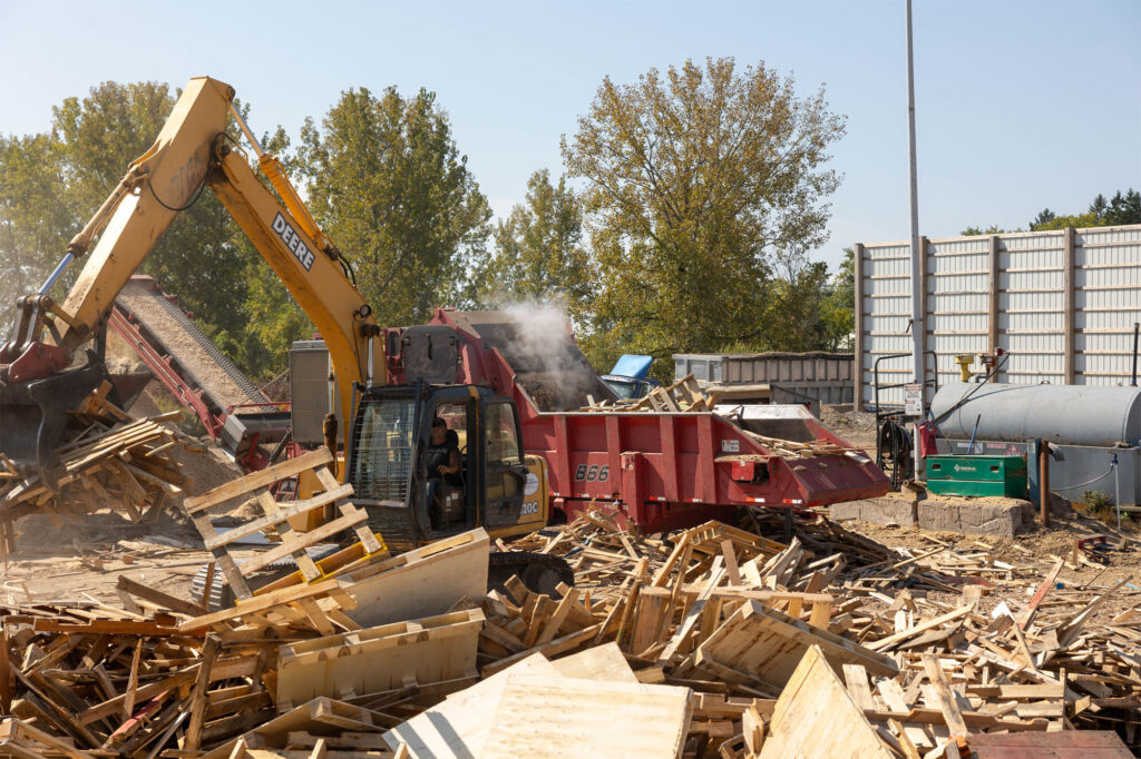 Power Pallet Employee Working with Heavy Equipment